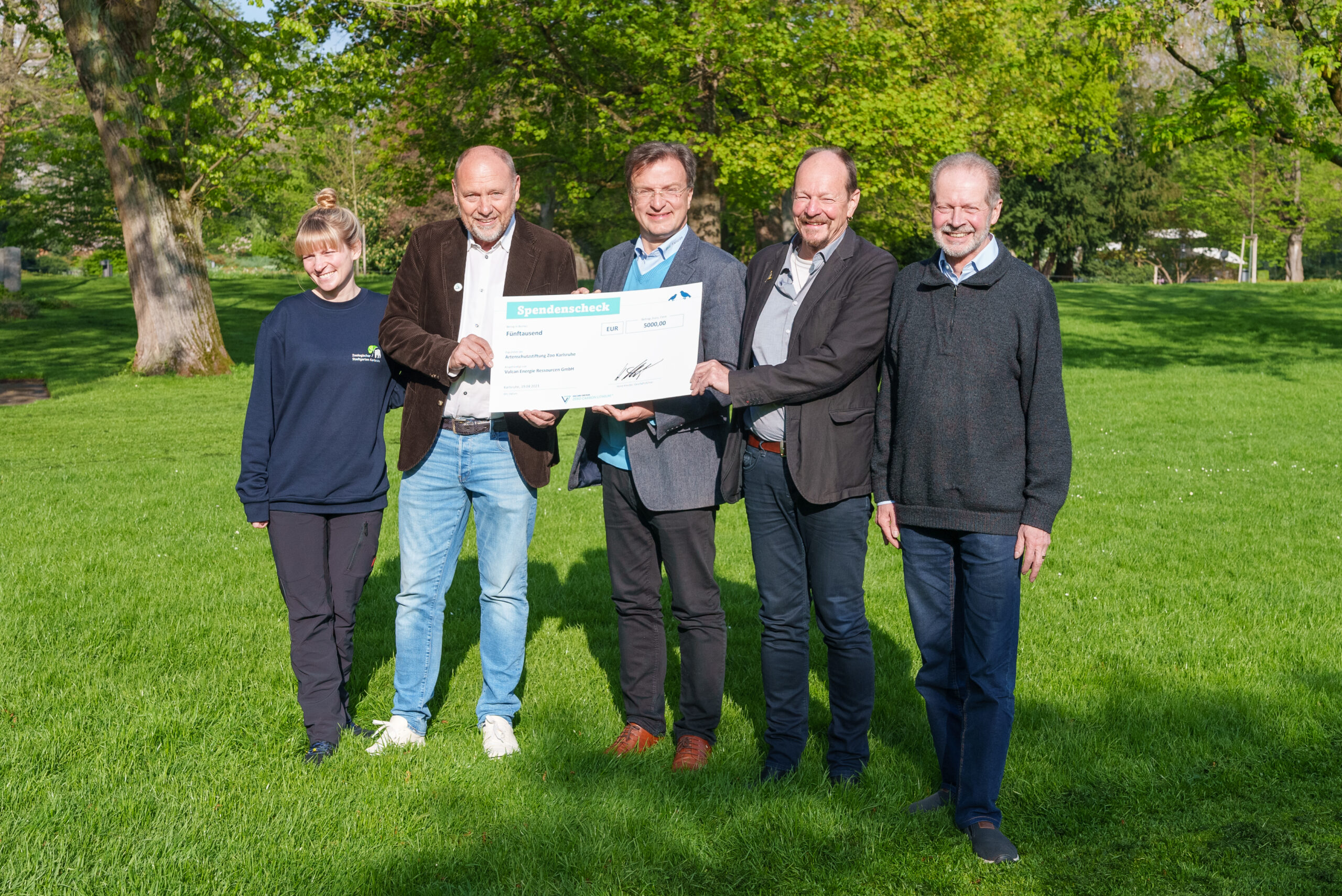 Horst Kreuter giving a check to people from the